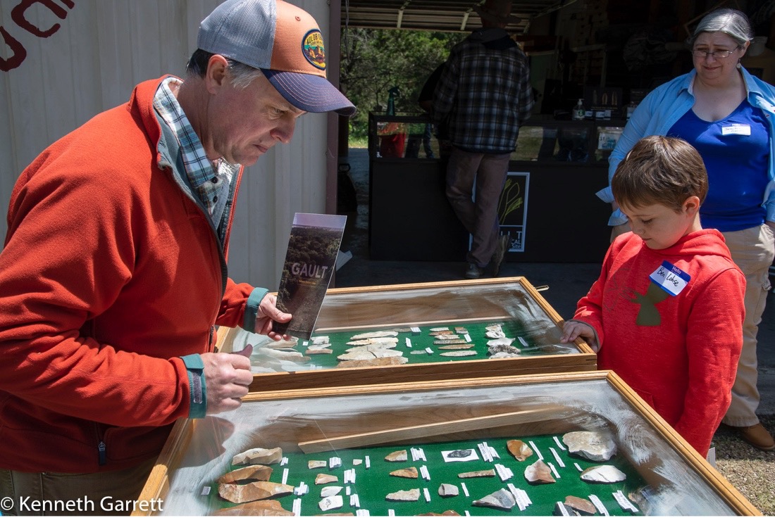 TAS member and GSAR Board member Joh Lohse and his son, Ben, study artifacts from Gault as GSAR staffer Jennifer Gandy looks on.